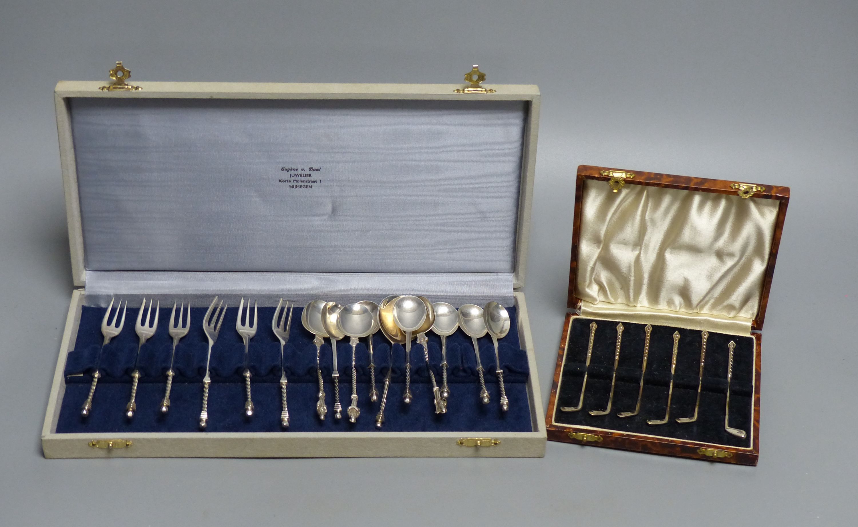 Two cased sets- Dutch white metal spoons & forks and a set of six sterling 'golf club' cocktail sticks? & 4 other spoons.
